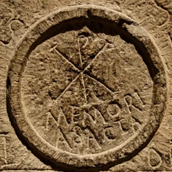 Detail from an altar stone depicting an abbreviation for the name of Jesus Christ