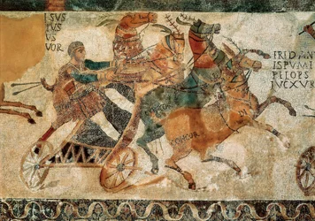 Roman art: mosaic representing a man on a chariot pulled by four horses (quadriga) during a race in a circus