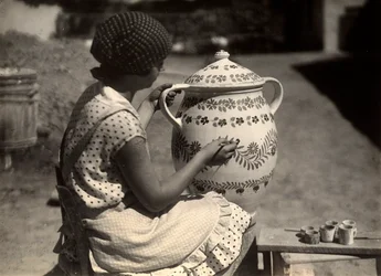 A Hungarian lady painting an amphora with floral motifs