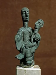 Nuragic culture: bronze statuette of Mother Goddess supporting a dead warrior. From Urzulei near Nuoro. Cagliari, Museo Nazionale Archeologico, Sardinia, Italy