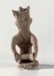 Cross-legged figure with an object thought to be a drum, from Susa, Iran, 4th-6th century AD