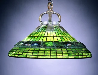 A leaded glass turtleback tile and bronze chandelier