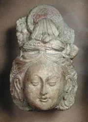 Head of a Bodhisattva with an elaborate hairstyle, from Tumshuq