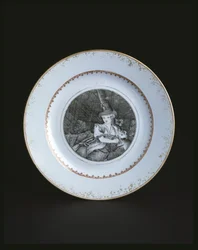 White plate bordered in gold and red with woman