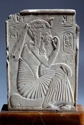 Egyptian antiquity: small limestone stele of Ramses II: the child king sits on the sign of the horizon. 19th dynasty. Paris, Louvre Museum