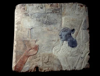 Relief of the temple of Thutmosis (Tuthmosis or Thutmus) III at Elephantine: Pharaoh followed by a goddess topped with columns of hieroglyphs. Sculpture in gres (stone), About 1390-1353 BC. From Aswan, Elephantine site. Paris, Louvre Museum