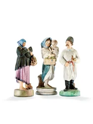 Three porcelain figures depicting two women holding children, and a Cossak with a pipe, late 19th century