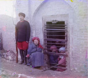 Zindan (traditional Central Asian prison pit) with uniformed guard, probably Bukhara