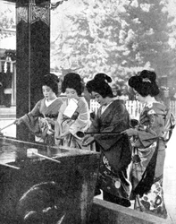 Japanese women washing their hands prior to entering a temple