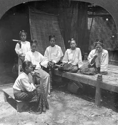 Burmese Women Smoking Outside Their Home, Mandalay, Burma
