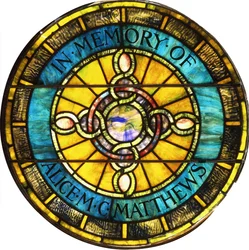 A circular leaded glass window by Tiffany Studios