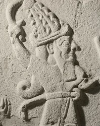 King Sulumeli pouring a libation with a god (detail)