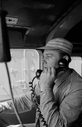 Charles Brockman, engineer of the Great Northern Railroad, speaks on radio phone from train