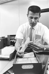 Computer operator Don Murray working with IBM early digital computer that use punch cards