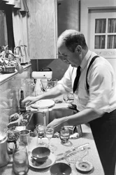 Reverend Lincoln Reed Washes Dishes in Kitchen After Family Sunday Supper