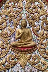 20151102, Vang Vieng, Laos: Entrance door ornamented with gold reliefs. The Teaching Buddha depicts a particular moment in the life of the Buddha, namely, the first sermon the Buddha gave after reaching Enlightenment