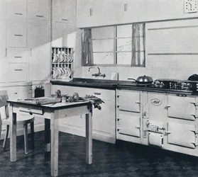Aga Heat Ltd. The Model F Aga Cooker for a large house finished in black and cream vitreous enamel