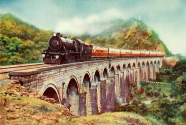 Between Bombay and Delhi: A Striking View of the Frontier Mail Passing Over a Viaduct