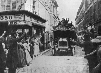 British Troops Receive a Welcome as They Arrive by Motor Van in a French Town