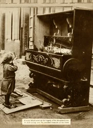 Child with damaged piano after an air raid made her homeless, First World War, 1918, 1935