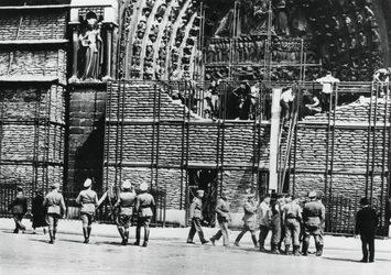 Clearing of sandbag protection from the facade of Notre Dame, German-occupied Paris