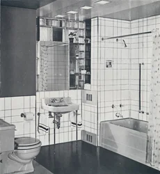 Crane Co. - A compact recess tiled in canary yellow, scored with orange, showing the stainless-steel