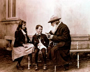 Leo Tolstoy telling his grandchildren a story, c. 1890-1910