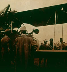 Machine gun mounted on a biplane, exhaust towards the top