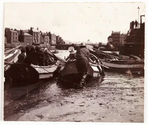 Man launching a fishing boat, Whitby Harbour, c 1901