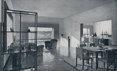 Paniconi and Pediconi. A dining room with a large window and curtains designed to frame a beautiful