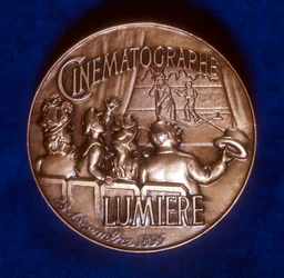 Reverse of medal commemorating 50 years of cinematography by the Lumiere brothers