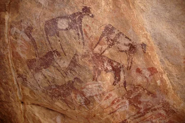 Rock Art, Prehistory: Painting of a Group of Cattle and Characters in an Ornate Shelter, Uweinat Massif, Sudan