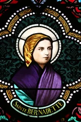Sacred heart church. Stained glass window: Ste Bernadette Soubirous, Moulins, France