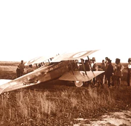 Soldiers surrounding biplane, Somme, northern France