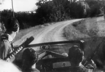 The Italian resistance movement: armed partisans on a jeep, Langhe, Piedmont, Italy