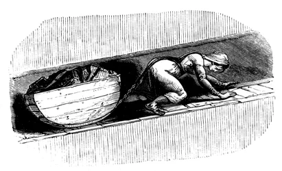 Woman putter dragging a sledge of coal along a narrow seam, South Wales