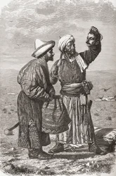 An Afghan soldier holding the severed head of his enemy