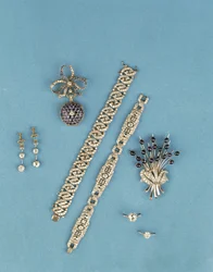 Selection of Art Deco jewellery: link bracelets; sapphire and diamond fob watch; solitaire rings; cabochon sapphire spray brooch