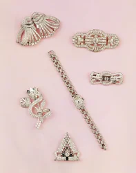 Selection of diamond jewellery: baguette and marquise-shaped diamond spray brooch; Art Deco diamond clip; panel diamond brooch; lady