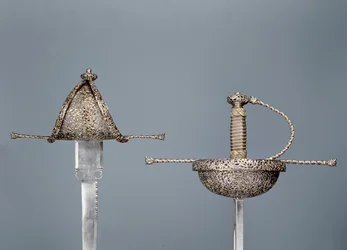 Swords: cup-hilted rapier of chiselled steel; left-handed dagger signed `Antonio Cilenta de Neapoli fecit, both 17th century