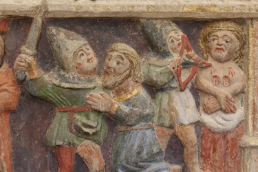 Altarpiece. polychrome stone. Second half 14th century. Origin former parish church of Torre de Rialb. (detail) Mid register. Left panel. Lower part: an official is looking at the scene at the beheading of Saint Iscle and the amputation of the breasts of S
