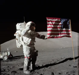 Astronaut Eugene A. Cernan, Apollo 17 commander, is photographed next to the deployed United States flag during lunar surface extravehicular activity (EVA) at the Taurus-Littrow landing site