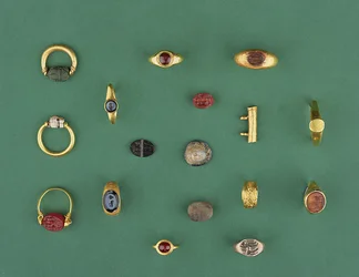 Collection of Roman, Etruscan and Hellenistic Jewellery including a Phoenician scarab ring, a cameo, amulet holders and an agate intaglio