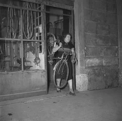 Cyclist Alfonsina Strada (Alfonsa Rosa Maria Morini) getting out of her shop on 80 Varesina street, Milan, Italy