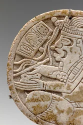 Detail from a Mayan shell roundel, depicting a crosslegged scribe with pen in hand, c.550-950