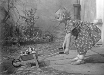 Little Girl Playing with a Wheelbarrow - 1931