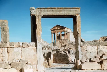 Roman ruins of the Capitol viewed through Dar el Acheb portal, Tunisia, Dougga