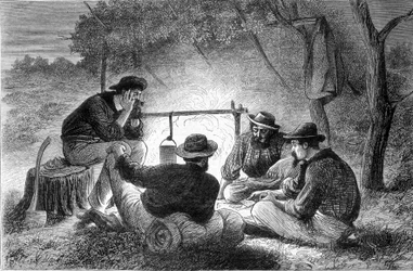 A game of maps around a campfire in Queenslaw, Australia