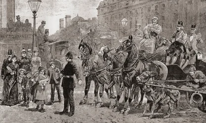 A Policeman Stops the Traffic on a Busy Crossing to Allow Pedestrians to Cross the Road, London, England