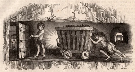 Two children pushing a trolley in an English coal mine, a third, the Trapper opens a door